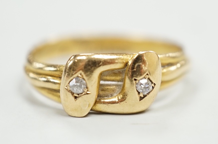 A late Victorian 18ct gold and two stone diamond set twin serpent ring, size L, gross weight 2.6 grams.